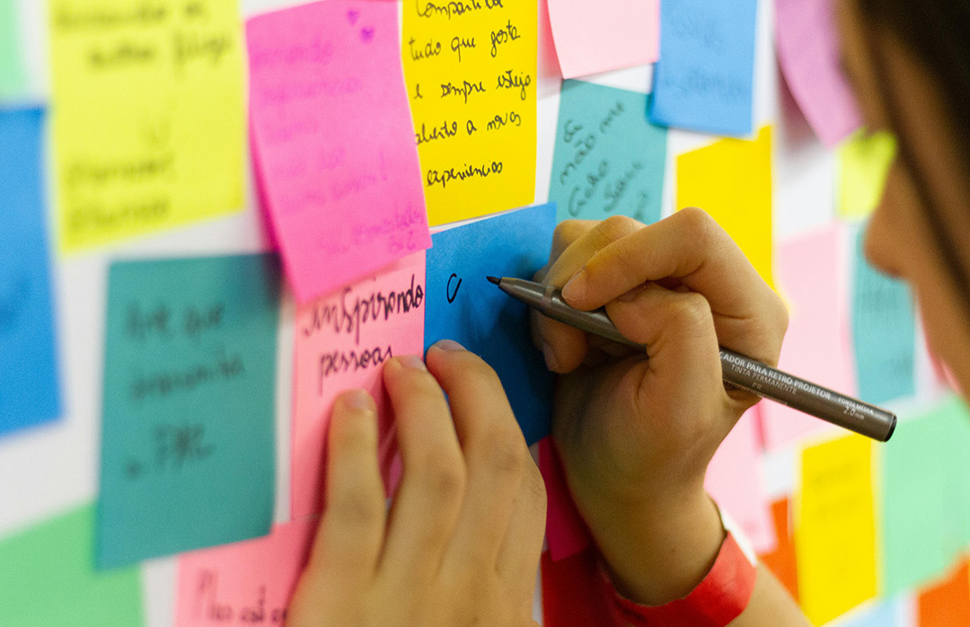 Person writing on sticky notes